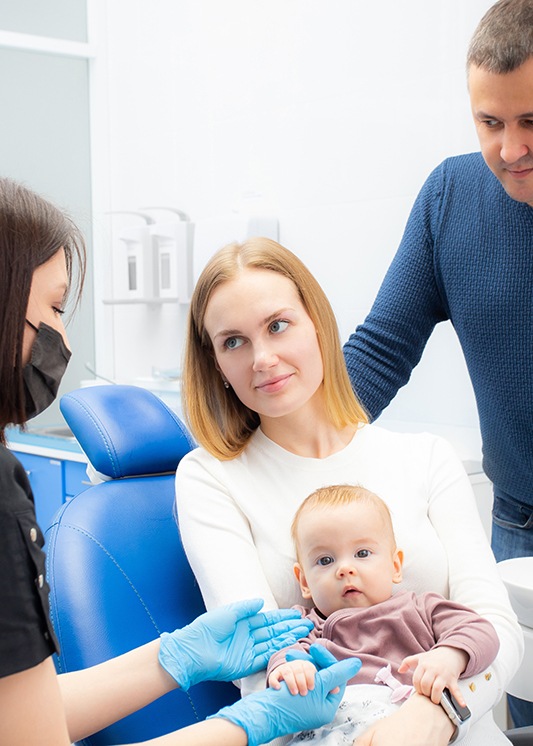 parents bringing their baby for a dental checkup