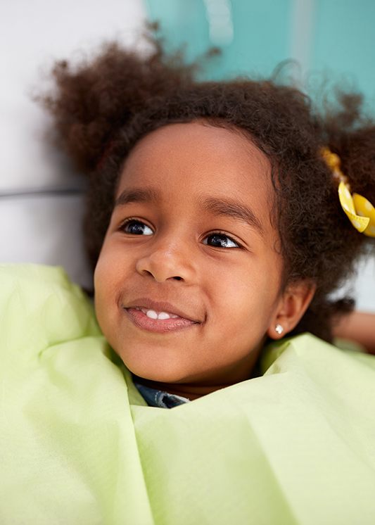 smiling little girl in the dentist chair