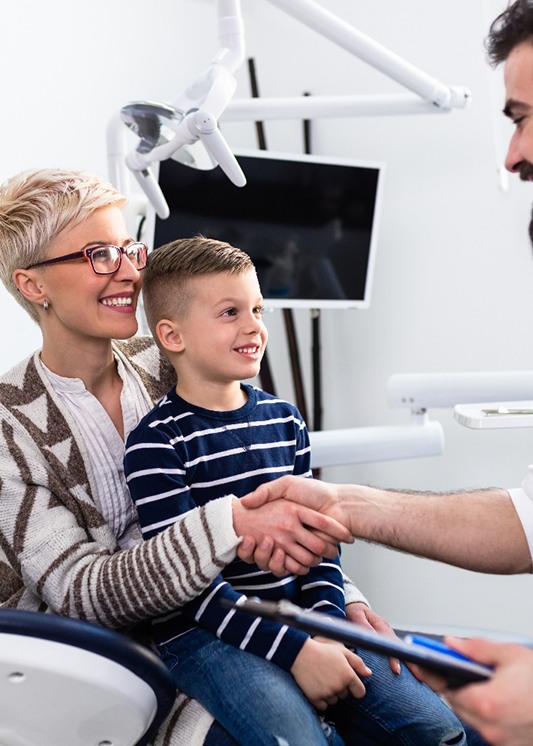 Dentist and mother shaking hands