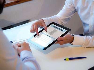 Parent reviewing dental insurance information on tablet