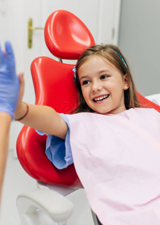 a child smiling during dental treatment